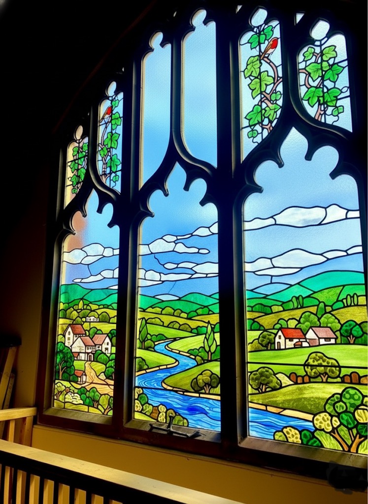 Restored Victorian stained glass window with pastoral river landscape